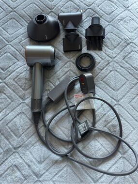 Dyson Hair Dryer with Multiple Black and Gray Styling Attachments